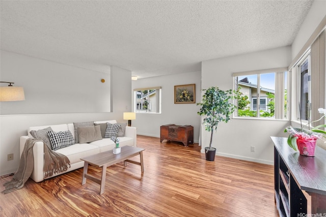 103 Kahako St Unit A, Kailua, HI 96734 - living area featuring a textured ceiling, light wood-type flooring, and baseboards