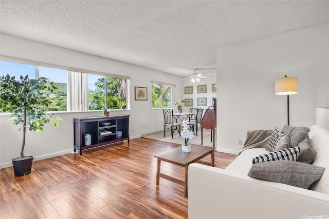103 Kahako St Unit A, Kailua, HI 96734 - living room featuring wood finished floors, a ceiling fan, a textured ceiling, and baseboards