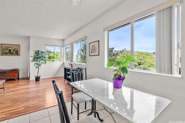 103 Kahako St Unit A, Kailua, HI 96734 - tiled dining area featuring a textured ceiling and baseboards