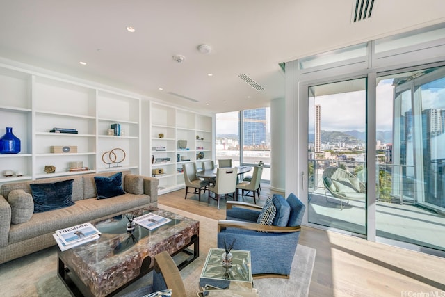 1118 Ala Moana Blvd Unit 1203, Honolulu, HI 96814 - living area with built in features, a mountain view, wood finished floors, and visible vents
