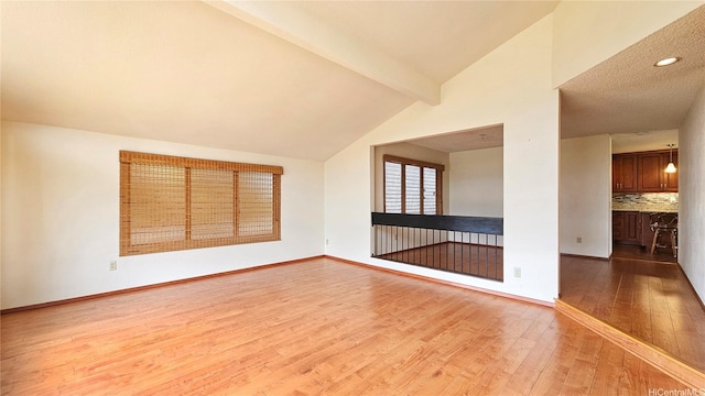 empty room with wood finished floors, baseboards, and recessed lighting