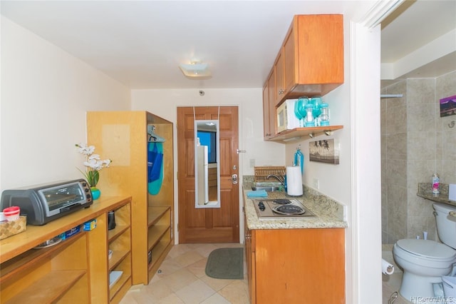 1700 Ala Moana Blvd Unit 1602, Honolulu, HI 96815 - kitchen featuring brown cabinets, a toaster, a sink, stainless steel electric stovetop, and light tile patterned flooring
