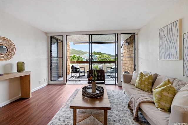1015 Aoloa Pl Unit 258, Kailua, HI 96734 - living area with baseboards, expansive windows, and wood finished floors