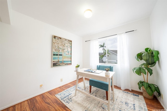 office space featuring baseboards and wood finished floors