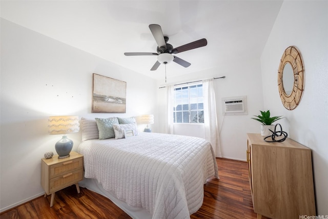 bedroom featuring ceiling fan, an AC wall unit, and dark wood-style floors