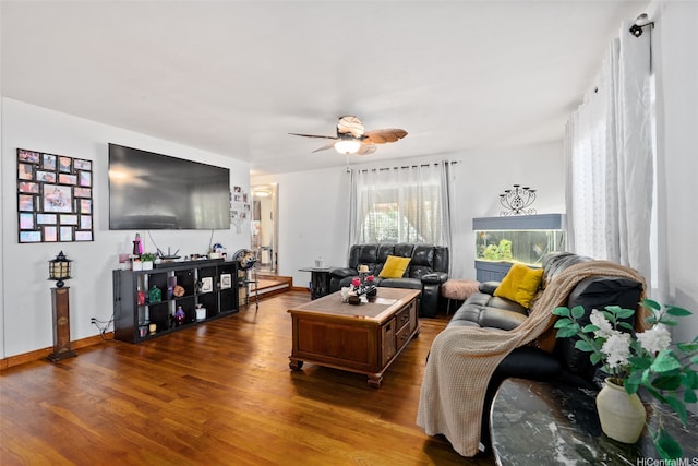 living room featuring ceiling fan, dark wood-style floors, and baseboards