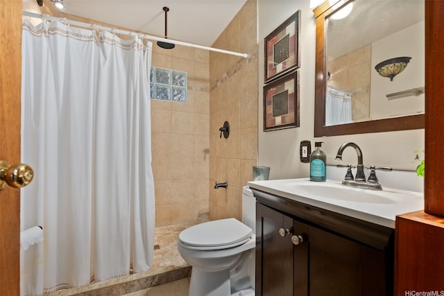 full bath featuring vanity, a tile shower, and toilet