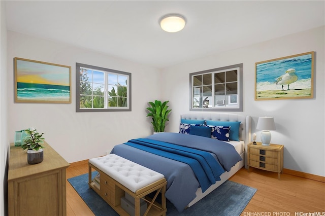bedroom with baseboards and light wood-type flooring