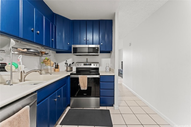 46-259 Kahuhipa St Unit 318B, Kaneohe, HI 96744 - kitchen with a sink, light countertops, blue cabinets, light tile patterned floors, and stainless steel appliances