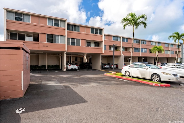 46-259 Kahuhipa St Unit 318B, Kaneohe, HI 96744 - view of property featuring covered and uncovered parking