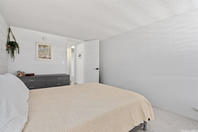 carpeted bedroom featuring a textured ceiling