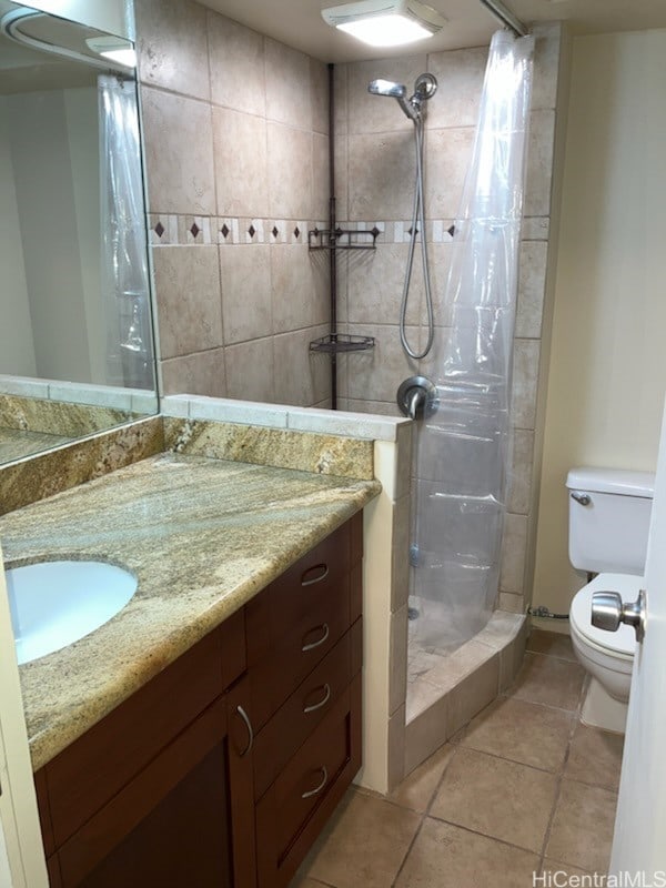 1700 Ala Moana Blvd Unit 3101, Honolulu, HI 96815 - full bathroom featuring vanity, tile patterned flooring, a stall shower, and toilet