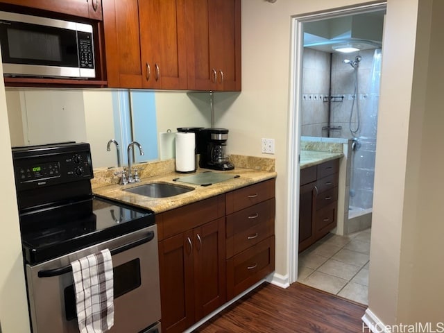 1700 Ala Moana Blvd Unit 3101, Honolulu, HI 96815 - kitchen featuring range with electric cooktop, light stone countertops, dark wood finished floors, a sink, and stainless steel microwave