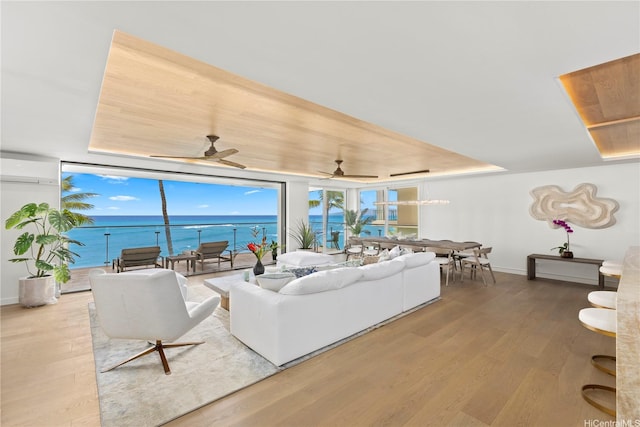 living room with a wall of windows, baseboards, and wood finished floors