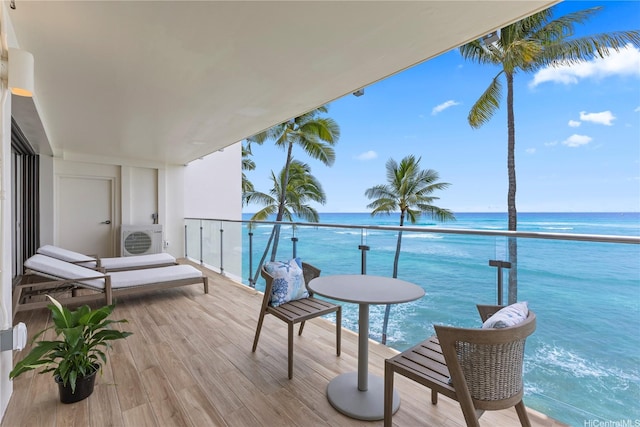 balcony featuring a water view and ac unit