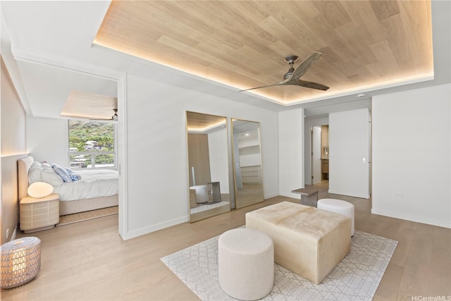 bedroom with baseboards, ceiling fan, wood finished floors, and wooden ceiling