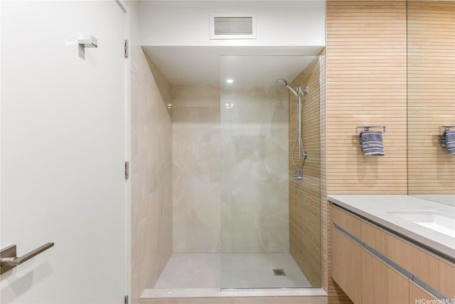 full bathroom featuring visible vents, vanity, and a shower stall