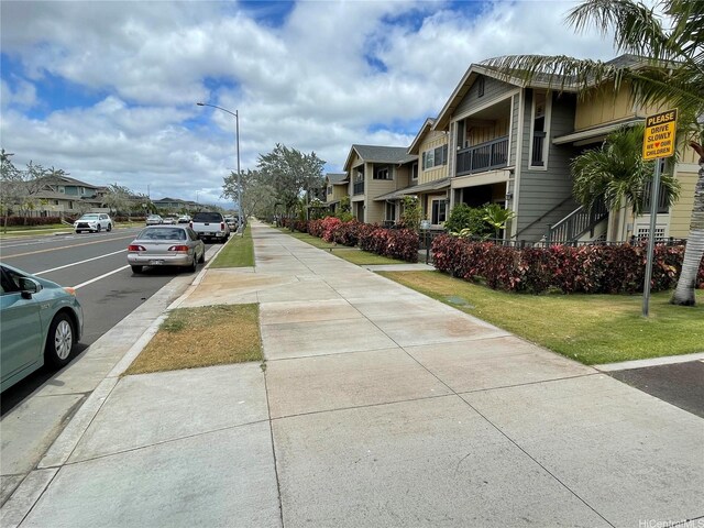 91-960 Iwikuamoo St Unit 304, Ewa Beach, HI 96706 - view of street featuring a residential view, sidewalks, street lighting, and curbs