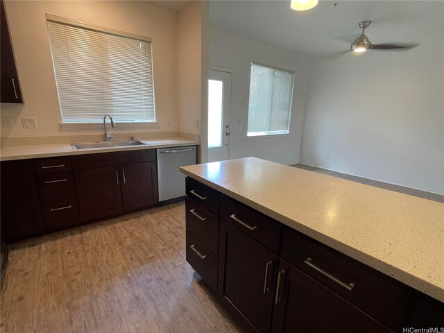 91-960 Iwikuamoo St Unit 304, Ewa Beach, HI 96706 - kitchen with stainless steel dishwasher, a ceiling fan, a sink, light wood-style flooring, and a wealth of natural light