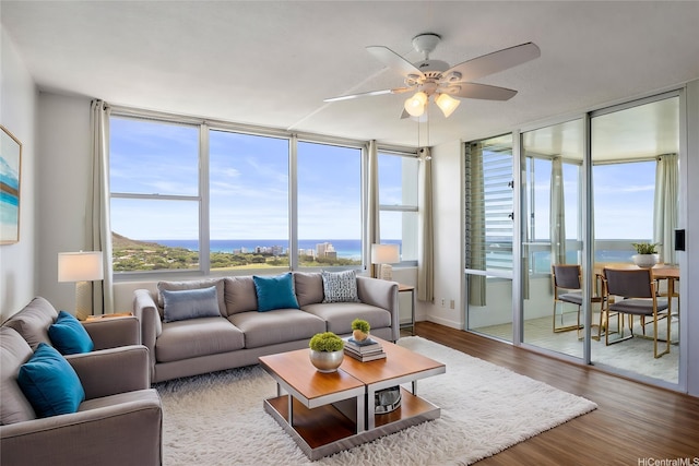 2600 Pualani Way Unit 3102, Honolulu, HI 96815 - living area with ceiling fan, expansive windows, and wood finished floors