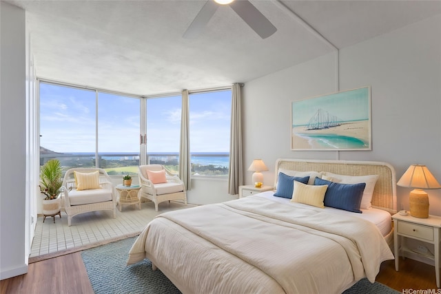 2600 Pualani Way Unit 3102, Honolulu, HI 96815 - bedroom featuring wood finished floors, a ceiling fan, and expansive windows