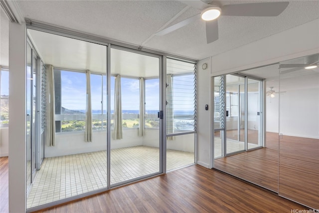 2600 Pualani Way Unit 3102, Honolulu, HI 96815 - unfurnished sunroom with wood finished floors and a textured ceiling