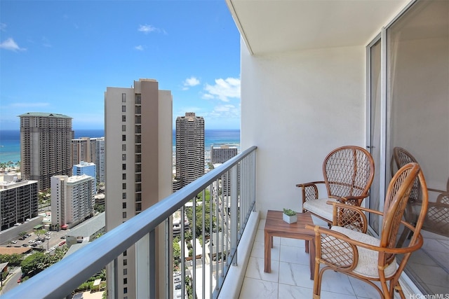 balcony with a water view and central AC