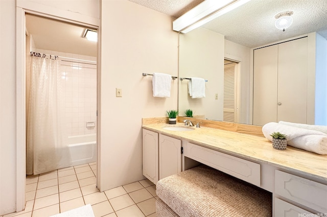 bathroom with vanity, a textured ceiling, shower / bathtub combination with curtain, and tile patterned flooring