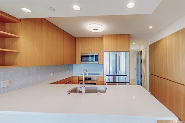 1388 Kapiolani Blvd Unit 2209, Honolulu, HI 96814 - kitchen with a peninsula, light countertops, stainless steel appliances, and backsplash