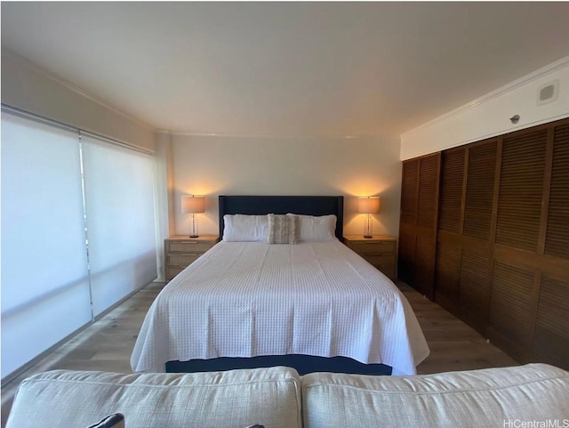 1777 Ala Moana Blvd Unit 901, Honolulu, HI 96815 - bedroom featuring ornamental molding, a closet, wood finished floors, and visible vents