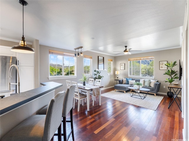 living room featuring baseboards, crown molding, dark wood finished floors, and ceiling fan