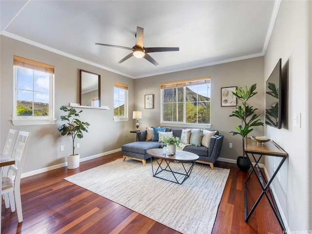 living area featuring baseboards, ceiling fan, ornamental molding, and hardwood / wood-style floors