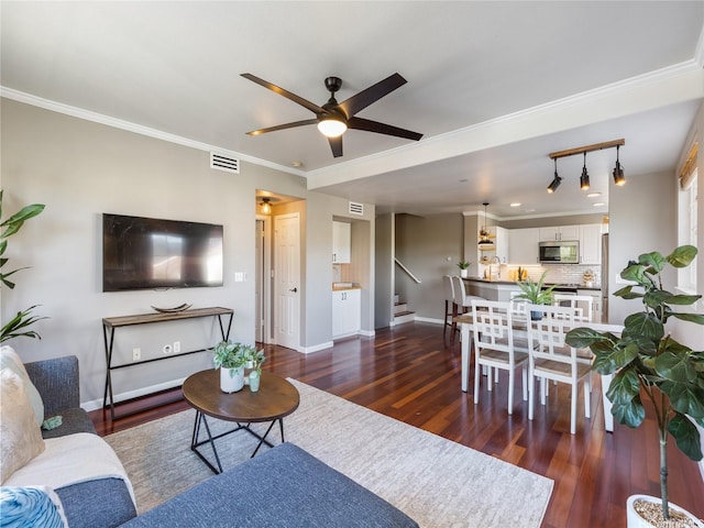 living room featuring visible vents, baseboards, ceiling fan, stairway, and dark wood finished floors