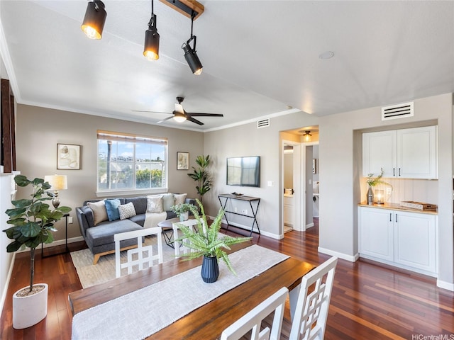 dining area featuring visible vents, a ceiling fan, dark wood finished floors, and baseboards