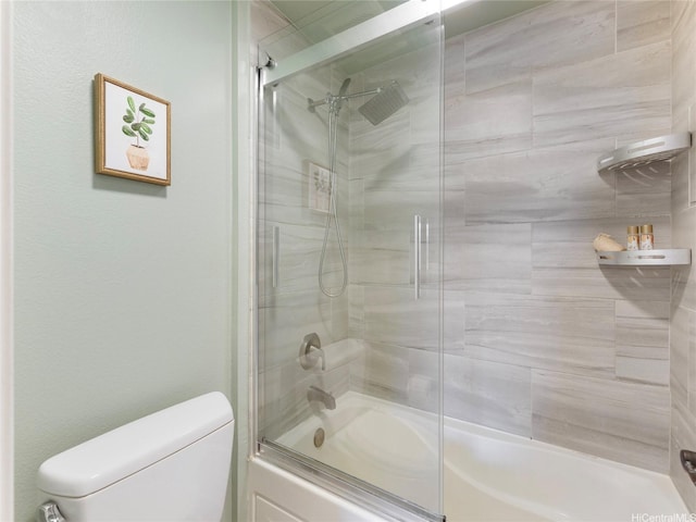 bathroom with enclosed tub / shower combo and toilet