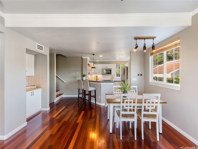 dining space featuring visible vents, baseboards, ornamental molding, stairs, and dark wood-type flooring