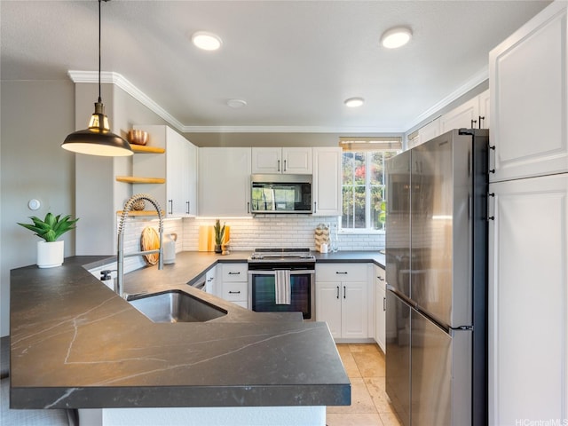 kitchen featuring dark countertops, open shelves, a sink, a peninsula, and stainless steel appliances