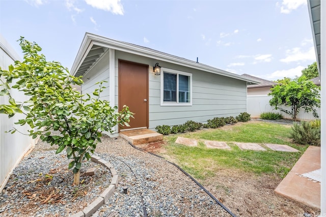 91-1023 Kai Weke St, Ewa Beach, HI 96706 - view of side of home featuring a fenced backyard and a yard