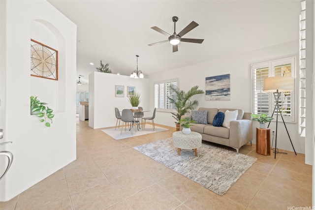 91-1023 Kai Weke St, Ewa Beach, HI 96706 - living area featuring light tile patterned floors, arched walkways, ceiling fan with notable chandelier, and lofted ceiling