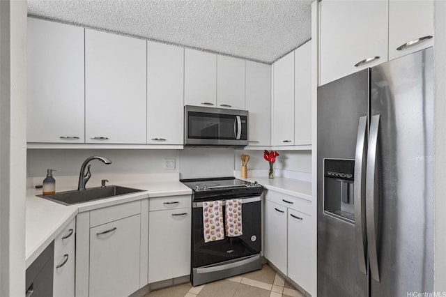 927 Prospect St Unit 604, Honolulu, HI 96822 - kitchen featuring light countertops, a textured ceiling, white cabinets, a sink, and stainless steel appliances