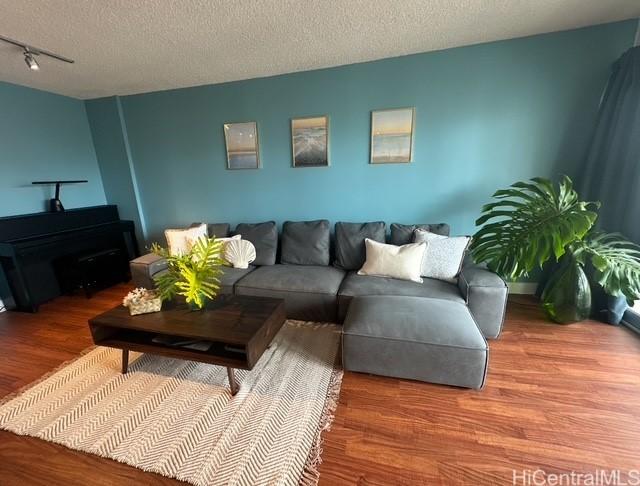 927 Prospect St Unit 604, Honolulu, HI 96822 - living area with track lighting, a textured ceiling, and wood finished floors