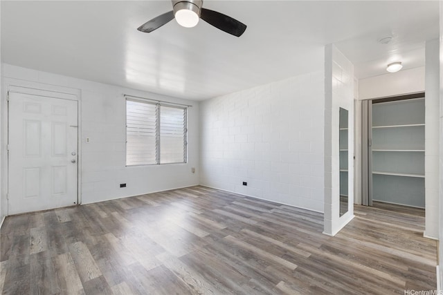 94-245 Leowahine St Unit 239, Waipahu, HI 96797 - interior space with ceiling fan, wood finished floors, a spacious closet, and concrete block wall