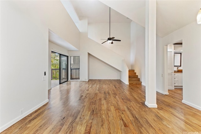 46-130 Kiowai St Unit 2724, Kaneohe, HI 96744 - unfurnished living room with baseboards, ceiling fan, wood finished floors, and stairway