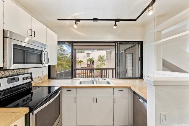46-130 Kiowai St Unit 2724, Kaneohe, HI 96744 - kitchen with light countertops, a sink, white cabinets, and stainless steel appliances