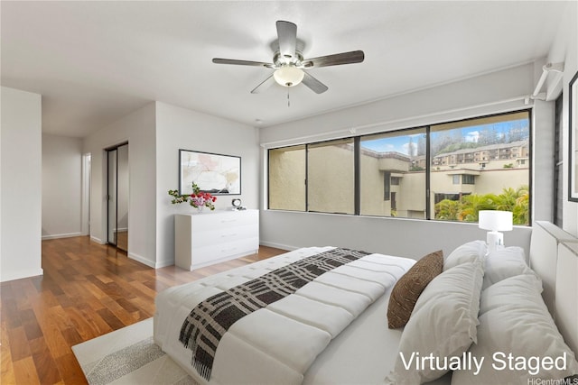 46-130 Kiowai St Unit 2724, Kaneohe, HI 96744 - bedroom featuring a ceiling fan, baseboards, and wood finished floors