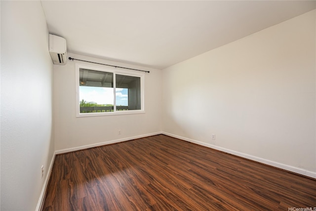94-1081 Anania Cir Unit 12, Mililani, HI 96789 - unfurnished room with baseboards, a wall unit AC, and dark wood-style flooring
