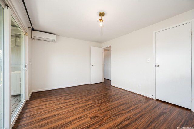 94-1081 Anania Cir Unit 12, Mililani, HI 96789 - unfurnished bedroom with baseboards, an AC wall unit, and wood finished floors