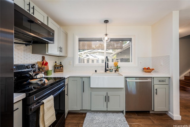 94-1081 Anania Cir Unit 12, Mililani, HI 96789 - kitchen featuring dark wood-style flooring, stainless steel dishwasher, black range with electric stovetop, a sink, and light countertops