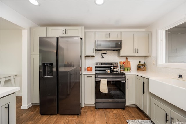 94-1081 Anania Cir Unit 12, Mililani, HI 96789 - kitchen featuring light countertops, stainless steel appliances, wood finished floors, and tasteful backsplash