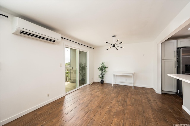 94-1081 Anania Cir Unit 12, Mililani, HI 96789 - interior space featuring baseboards, dark wood finished floors, a wall mounted air conditioner, and a chandelier
